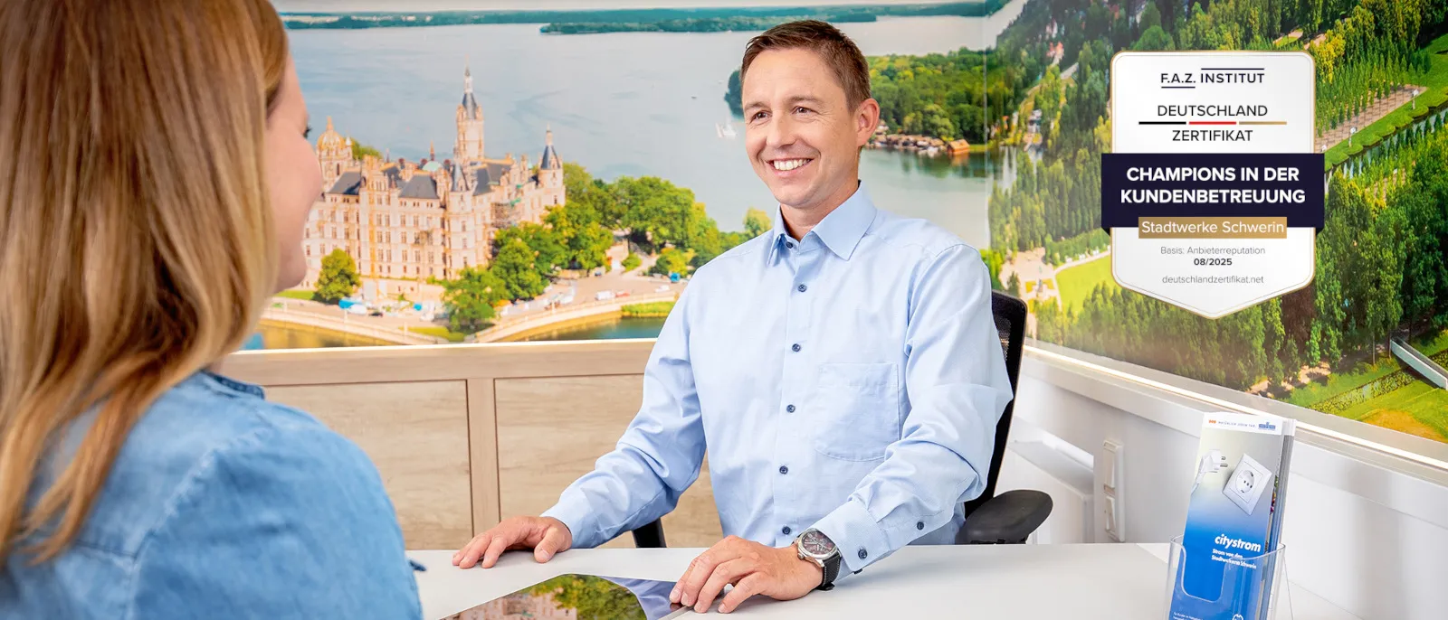 Ein Mitarbeiter der Stadtwerke Schwerin berät eine Kundin im Kundencenter.