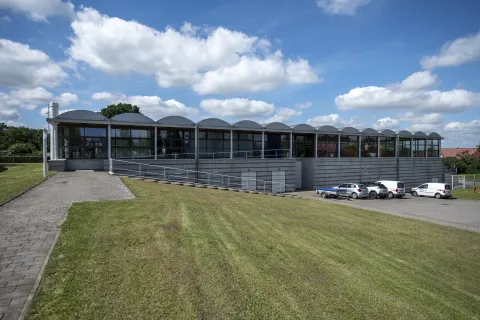 Eine Werkshalle mit einem wellenförmigen Dach.