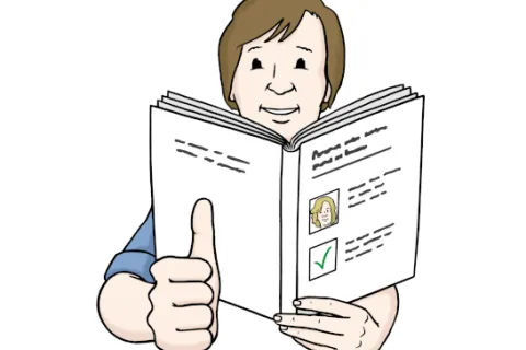 Ein Mann hält ein Buch in der Handen und zeigt mit dem Daumen nach oben.