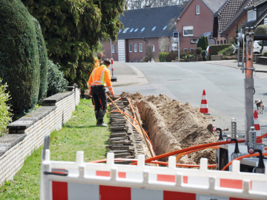Netzausbau, auf der Baustelle werden Kabel in einen Schacht verlegt