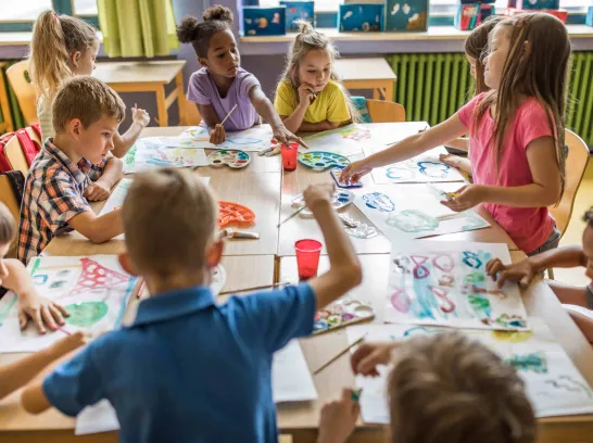 Schüler malen gemeinsam in der Schule.